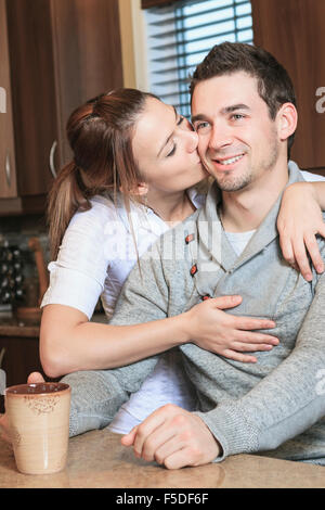 Young couple posing in their kitchen Stock Photo