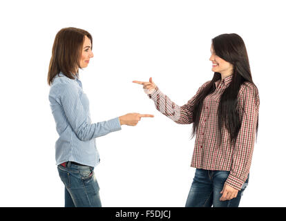 Two young girls pointing towards each other Stock Photo