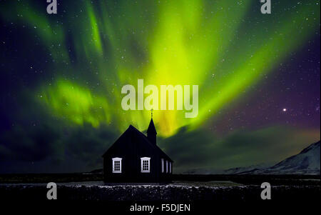 Bright polar lights shining over nice small village in ...