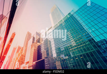 Vintage toned Manhattan skyscrapers at sunset, NYC, USA. Stock Photo