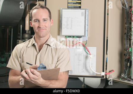 Air Conditioner Repair Man at work Stock Photo