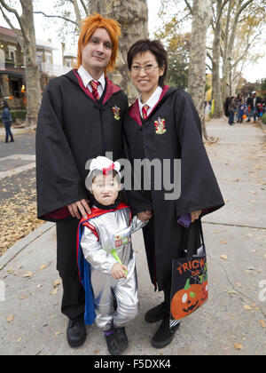 Family trick-or-treating n the Kensington section of Brooklyn, New York, 2015. Parents dressed as characters from Harry Potter. Stock Photo