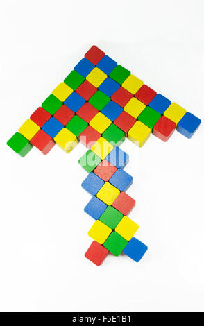 Multiple colored cubes arranged in the shape of an arrow pointed upwards, isolated on white Stock Photo