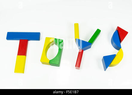 The word 'toys' written using colored wooden pieces , isolated on white Stock Photo