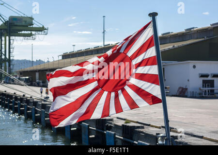 Japanese Naval Ensign, called the Rising Sun Flag, as flown since 1954. Its design is still very close to the one used in WWII. Stock Photo