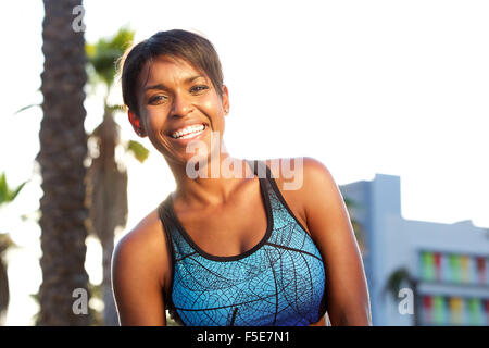 Close up portrait of an sporty attractive african american woman laughing Stock Photo
