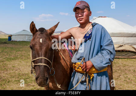 Portrait of nomad in deel with his horse, Nomad gers, Khogno Khan Uul Nature Reserve, Gurvanbulag, Bulgan, Northern Mongolia Stock Photo