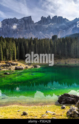 Latemar group reflected in the green waters of Lake Carezza, Ega Valley, South Tyrol Trentino-Alto Adige, Dolomites, Italy Stock Photo