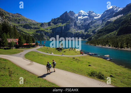 Hikers around Lake Oeschinensee, Bernese Oberland, Kandersteg, Canton of Bern, Switzerland, Europe Stock Photo