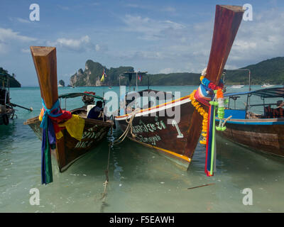 Tourists on long-tail boat in the Phi Phi islands, Andaman Sea, Thailand, Southeast Asia, Asia Stock Photo