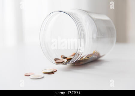 close up of euro coins in glass jar on table Stock Photo