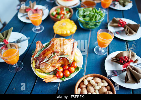 Baked turkey and other traditional Thanksgiving food on served table Stock Photo