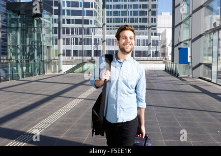 Portrait of a happy man at airport leaving for vacation Stock Photo