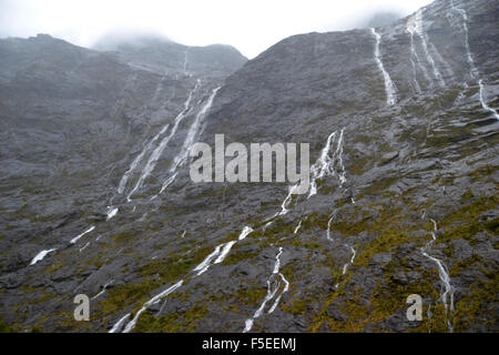 Glacier waterfalls on the road to Milford Sound, Fiordland National Park, South Island, New Zealand Stock Photo