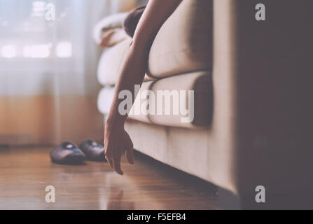 Woman lying on sofa relaxing Stock Photo