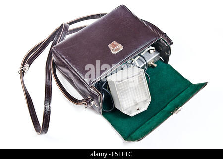 Old range finder vintage camera with flash isolated on white. Old camera flash with a leather case isolated on a white backgroun Stock Photo