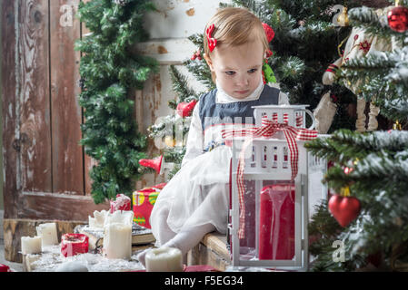 Happy girl with gifts and christmas tree Stock Photo