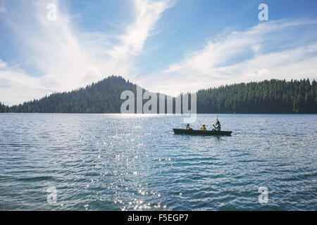 Man with two sons in a rowing boat Stock Photo