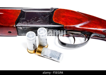 Hunting shotgun and ammunition on white background. Cartridges for hunting rifle. Close up view showing mechanism of rifle Stock Photo