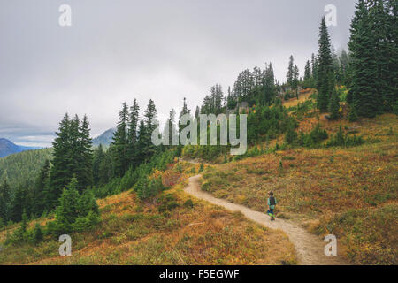 Boy walking along mountain path Stock Photo