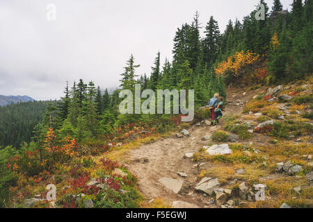 Two boys walking up a mountain path Stock Photo