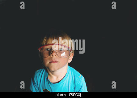 Portrait of boy wearing safety glasses Stock Photo