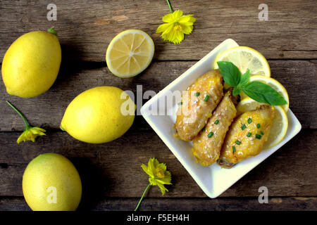 Lemon Chicken on wooden table Stock Photo
