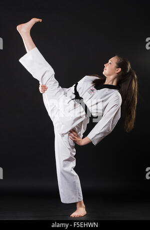 girl in kimono exercising karate kata Stock Photo