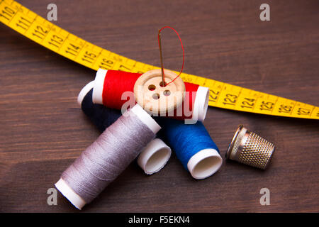 Accessories for sewing on dark wood table Stock Photo