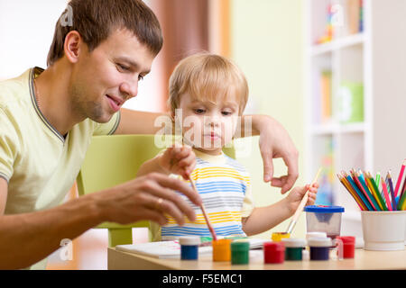 kid boy and dad paint together Stock Photo