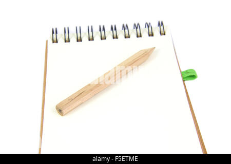 Pencil on notebook in a white background Stock Photo