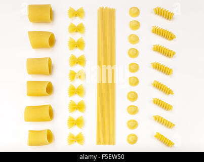 Italian pasta series. Paccheri, farfalle, spaghetti, orecchiette and fusilli on a white tablecloth. Stock Photo