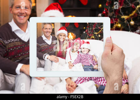 Composite image of hand holding tablet pc Stock Photo