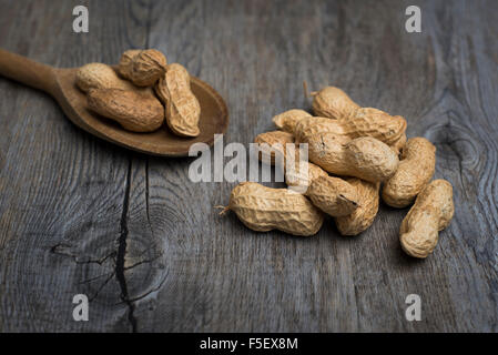 Pile of monkey nuts on a wooden spoon Stock Photo