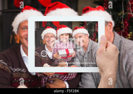 Composite image of hand holding tablet pc Stock Photo