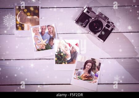 Composite image of happy father helping his son to put an angel on the christmas tree Stock Photo