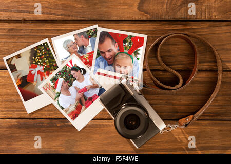 Composite image of senior man giving a kiss and a christmas present to his wife Stock Photo