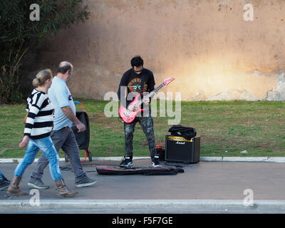 Hard rock guitarist playing on the streets of Rome, Italy, near the colosseum Stock Photo