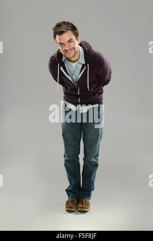 Portrait of young hip man posing over gray background Stock Photo