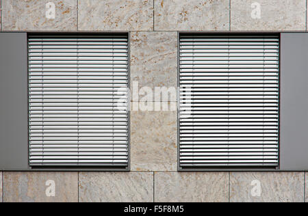 Two windows with silver shutters Stock Photo