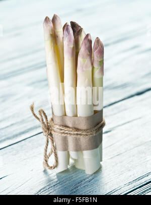 Shoots of white asparagus on the old wooden table. Stock Photo