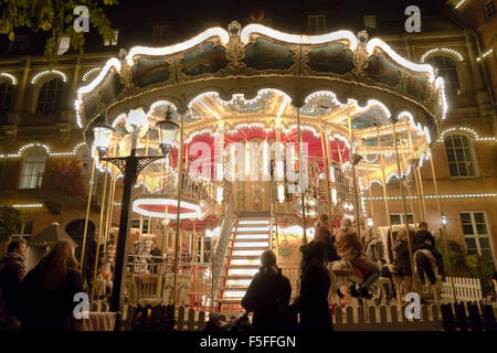 Brightly lit carousel on a dark Halloween night in the Tivoli Gardens, Copenhagen, Denmark. Stock Photo