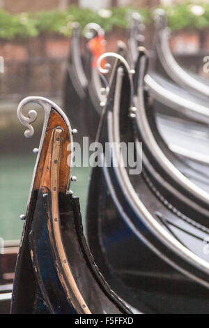 Metal parts on the back of a gondola called the risso. Many gondolas parked close together in a lagoon off the Grand Canal in Venice, Italy. Stock Photo