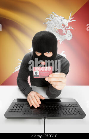 Hacker with ID card in hand and flag on background - Bhutan Stock Photo