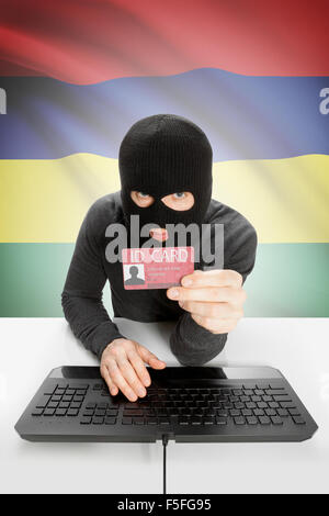 Hacker with ID card in hand and flag on background - Mauritius Stock Photo