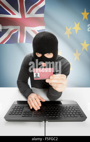 Hacker with ID card in hand and flag on background - Tuvalu Stock Photo