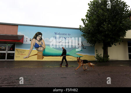 A painted wall in Sheerness, Kent, with a grumpy mermaid about to blow up the place with 'Welcome to Sheerness' in text above. Stock Photo