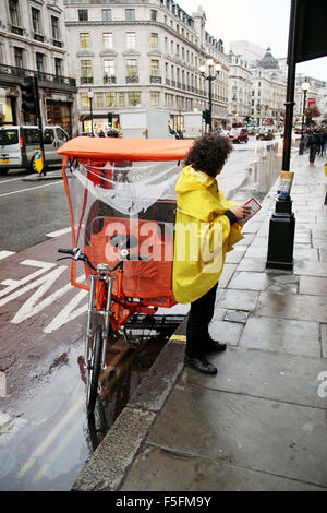 London, UK, UK. 12th Sep, 2011. A Pedicab or Rickshaw driver waits for a customer in the rain in the city center of London. © Ruaridh Stewart/ZUMAPRESS.com/Alamy Live News Stock Photo