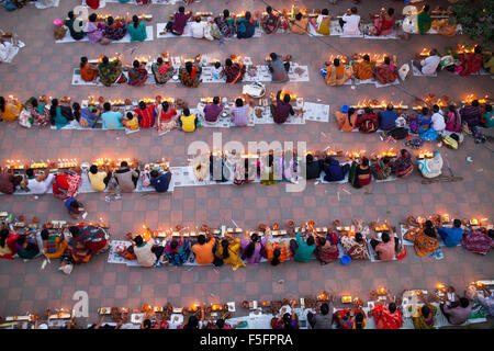 Dhaka, Bangladesh. 03rd Nov, 2015. Devotees attend prayer with burning incense and light oil lamps before break fasting during a religious festival called Rakher Upabash in Narayangonj. Bengali people of the Hindu faith in Bangladesh sit in prayer celebrating the 18th century Hindu Saint Baba Lokenath with a 'Rakher Upobas' prayer and fast day Every year thousands of Hindu devotees gather in front of Shri Shri Lokenath Brahmachari Ashram temple for the Kartik Brati or Rakher Upobash religious festival in Barodi, Near Dhaka, Bangladesh. Credit:  zakir hossain chowdhury zakir/Alamy Live News Stock Photo