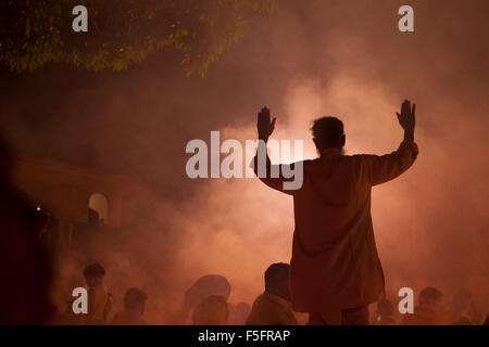 Dhaka, Bangladesh. 03rd Nov, 2015. Devotees attend prayer with burning incense and light oil lamps before break fasting during a religious festival called Rakher Upabash in Narayangonj. Bengali people of the Hindu faith in Bangladesh sit in prayer celebrating the 18th century Hindu Saint Baba Lokenath with a 'Rakher Upobas' prayer and fast day Every year thousands of Hindu devotees gather in front of Shri Shri Lokenath Brahmachari Ashram temple for the Kartik Brati or Rakher Upobash religious festival in Barodi, Near Dhaka, Bangladesh. Credit:  zakir hossain chowdhury zakir/Alamy Live News Stock Photo